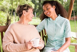 A-Caregiver-Smiling-with-a-Senior-Woman
